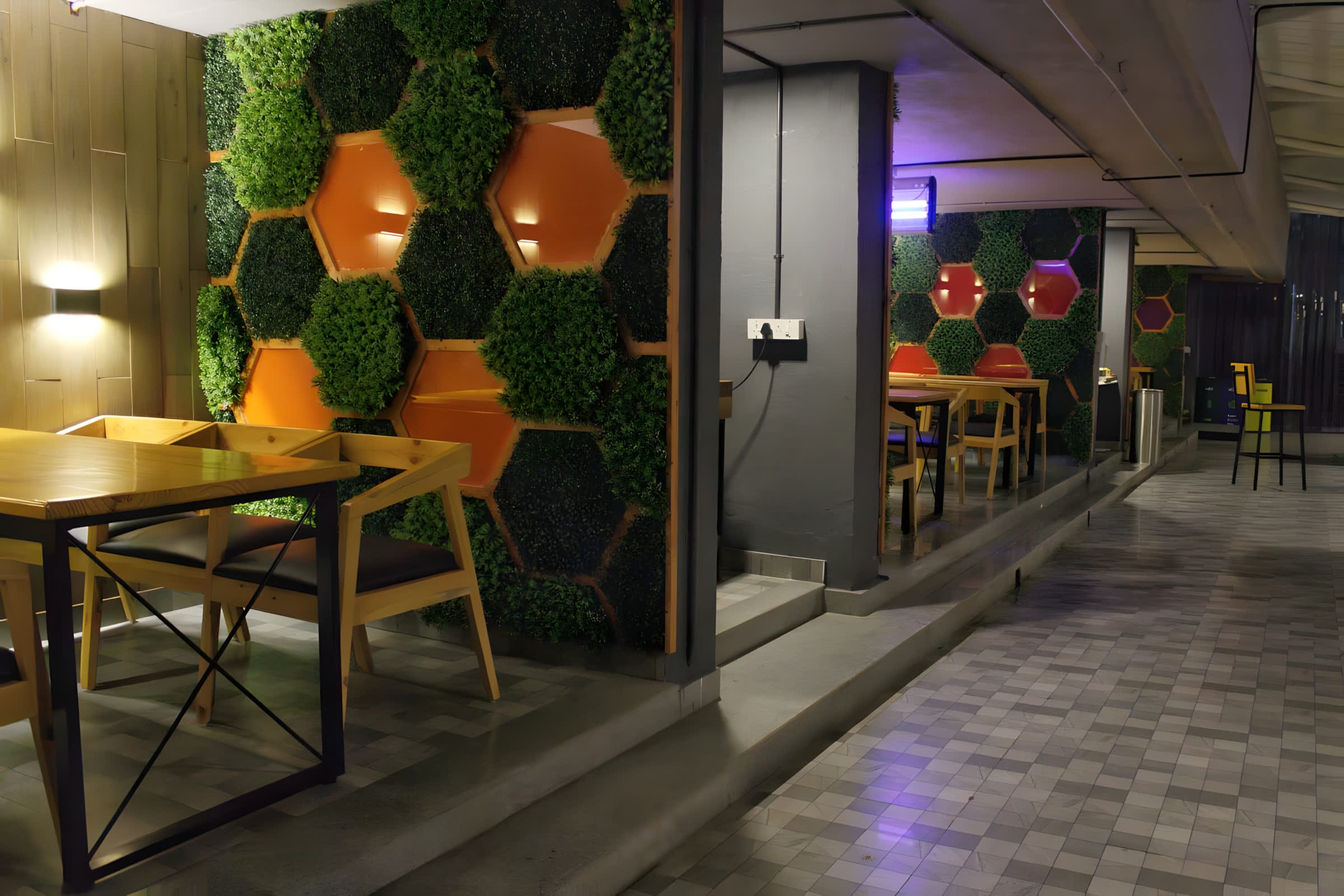 Green hexagonal moss feature wall in the cafeteria at Flock office