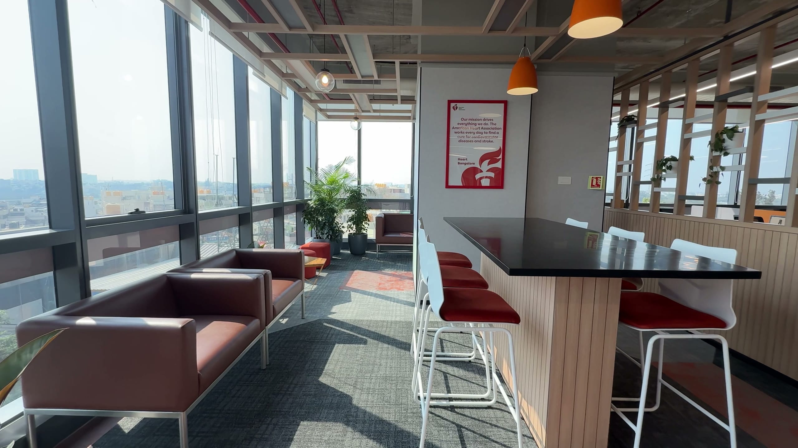Breakfast counter with red stools in the HPE office breakout area
