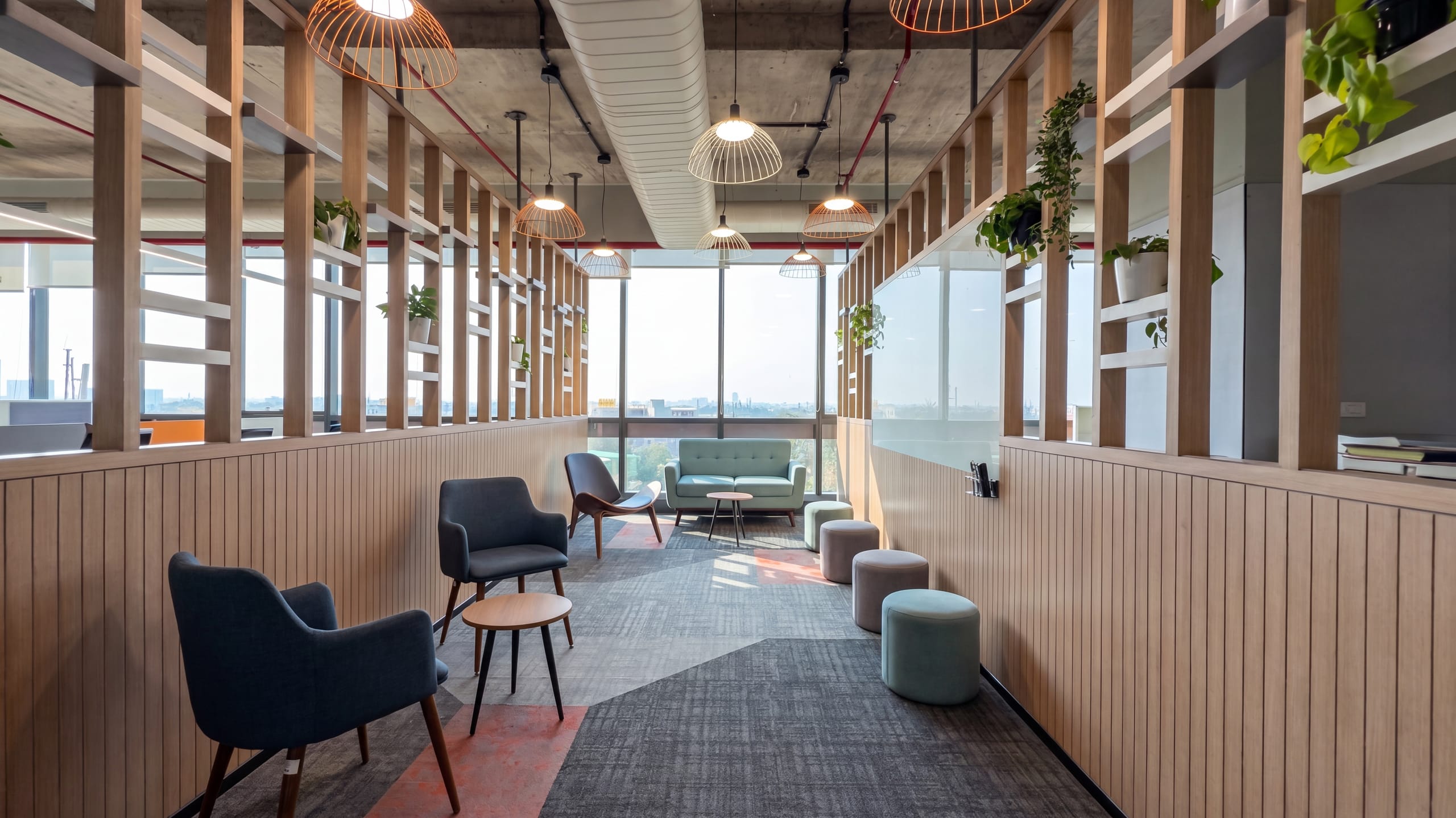 Window-lined breakout passage with blue sofa at HPE office