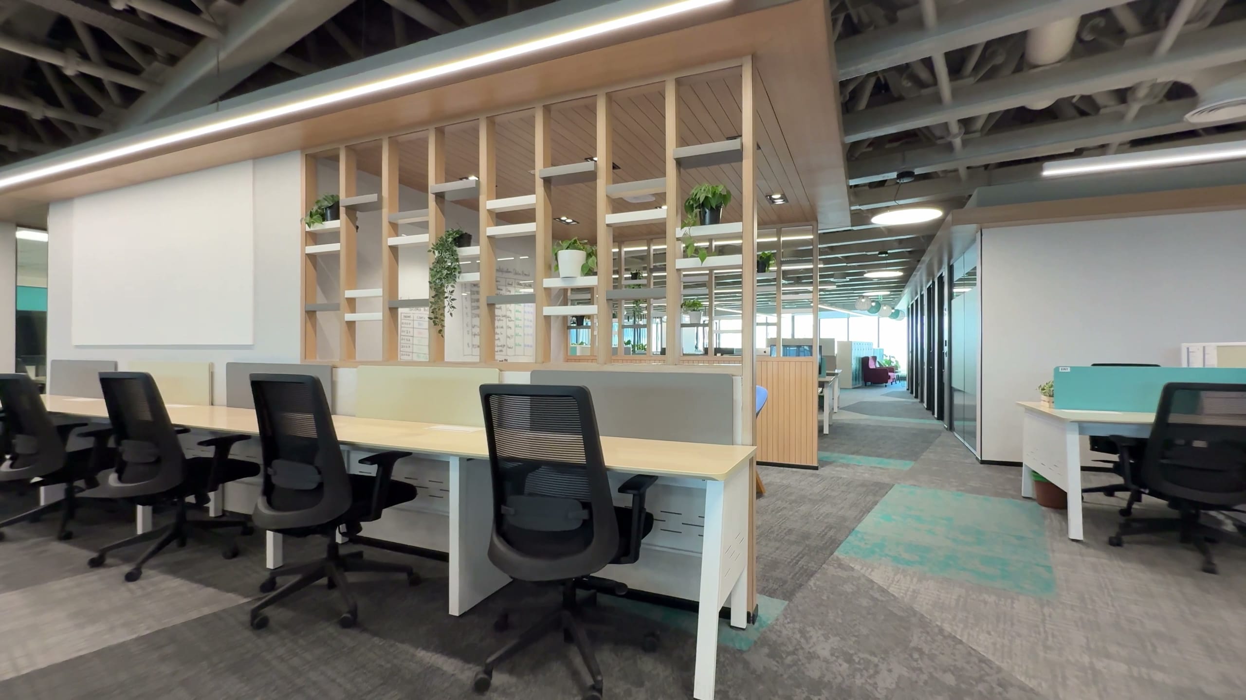 Workstations with a green plant wall at HPE office