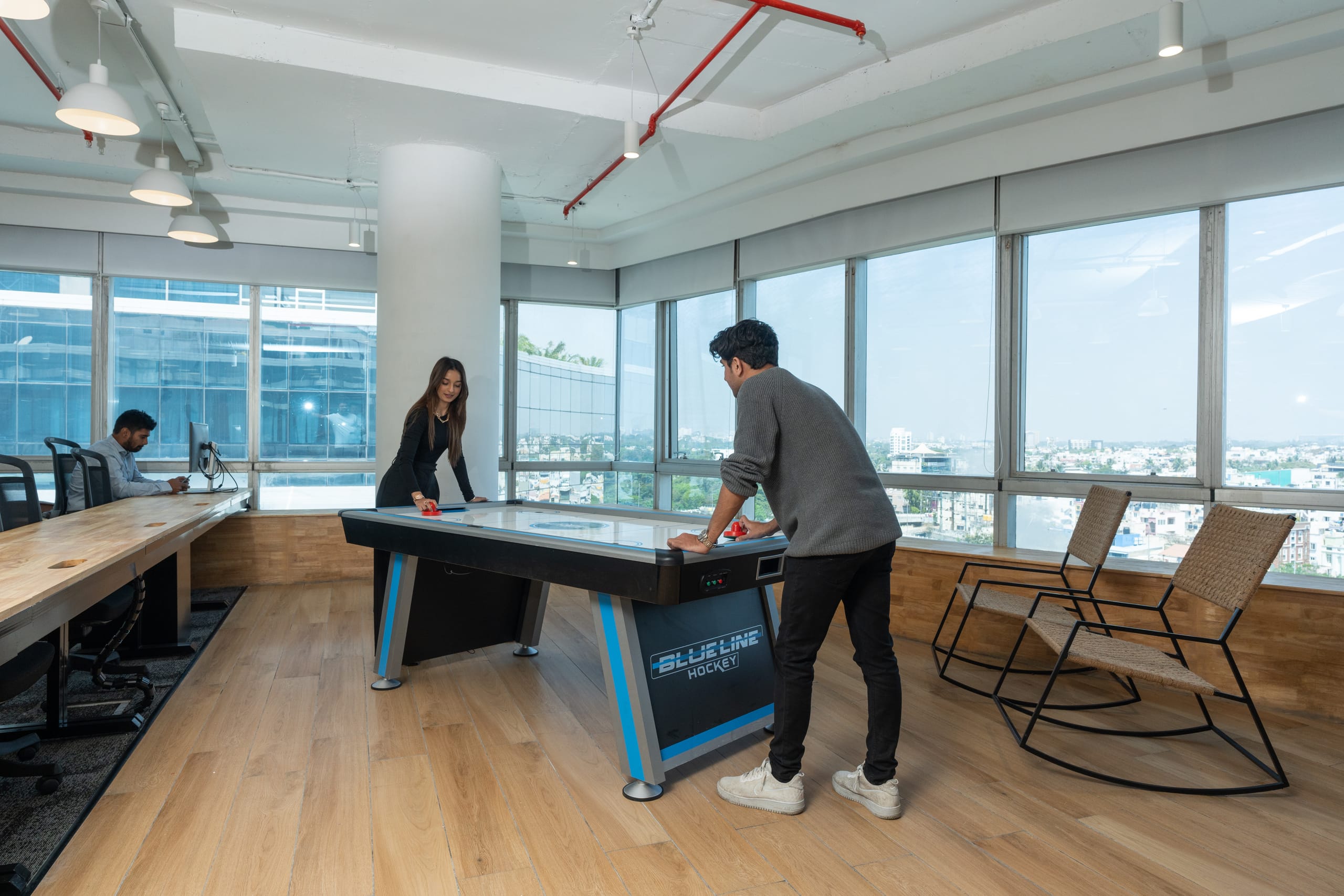 Recreation area with air hockey table by the window at MOSS office