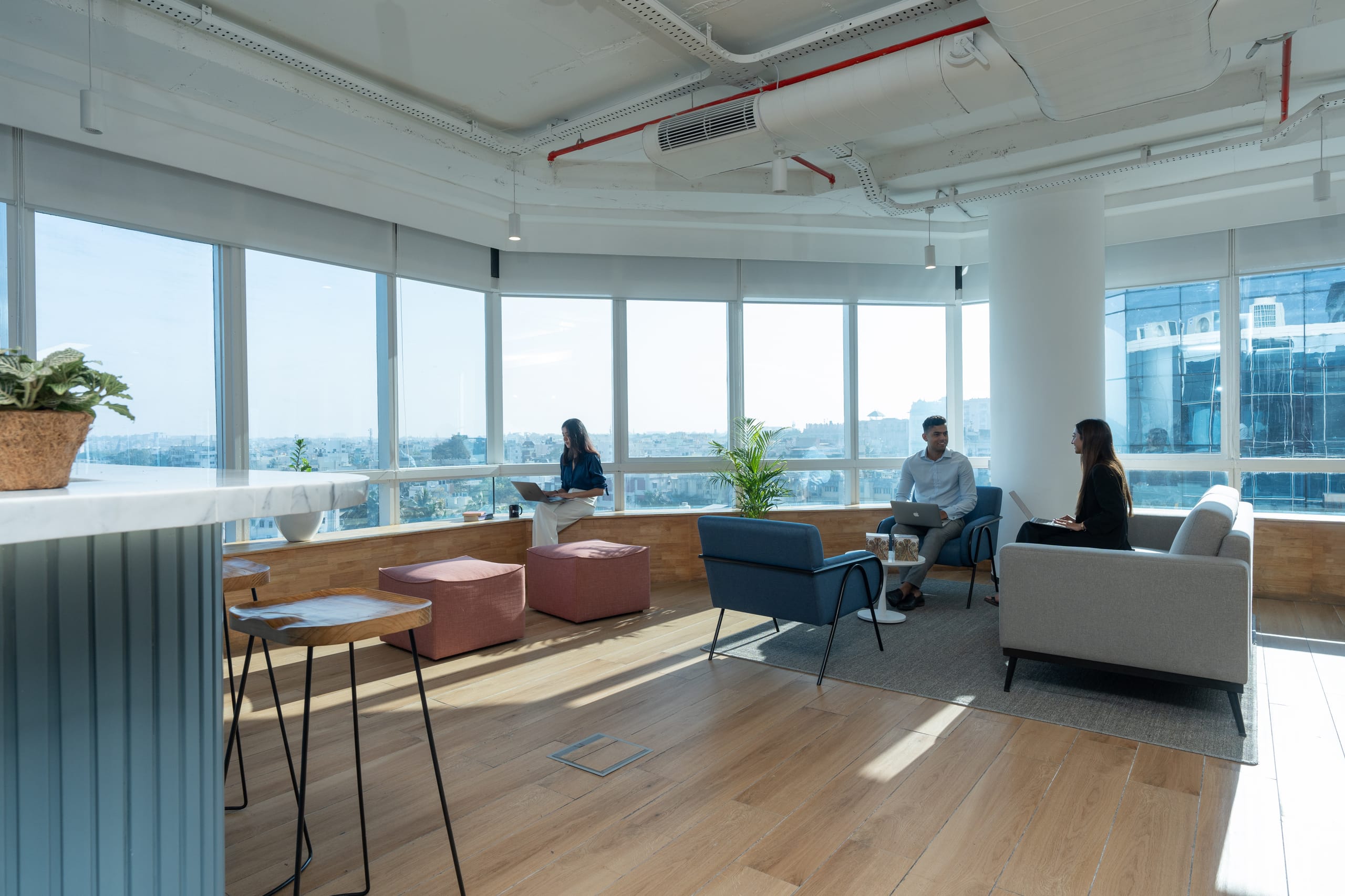 Staff relaxing in the window-side breakout area at MOSS office