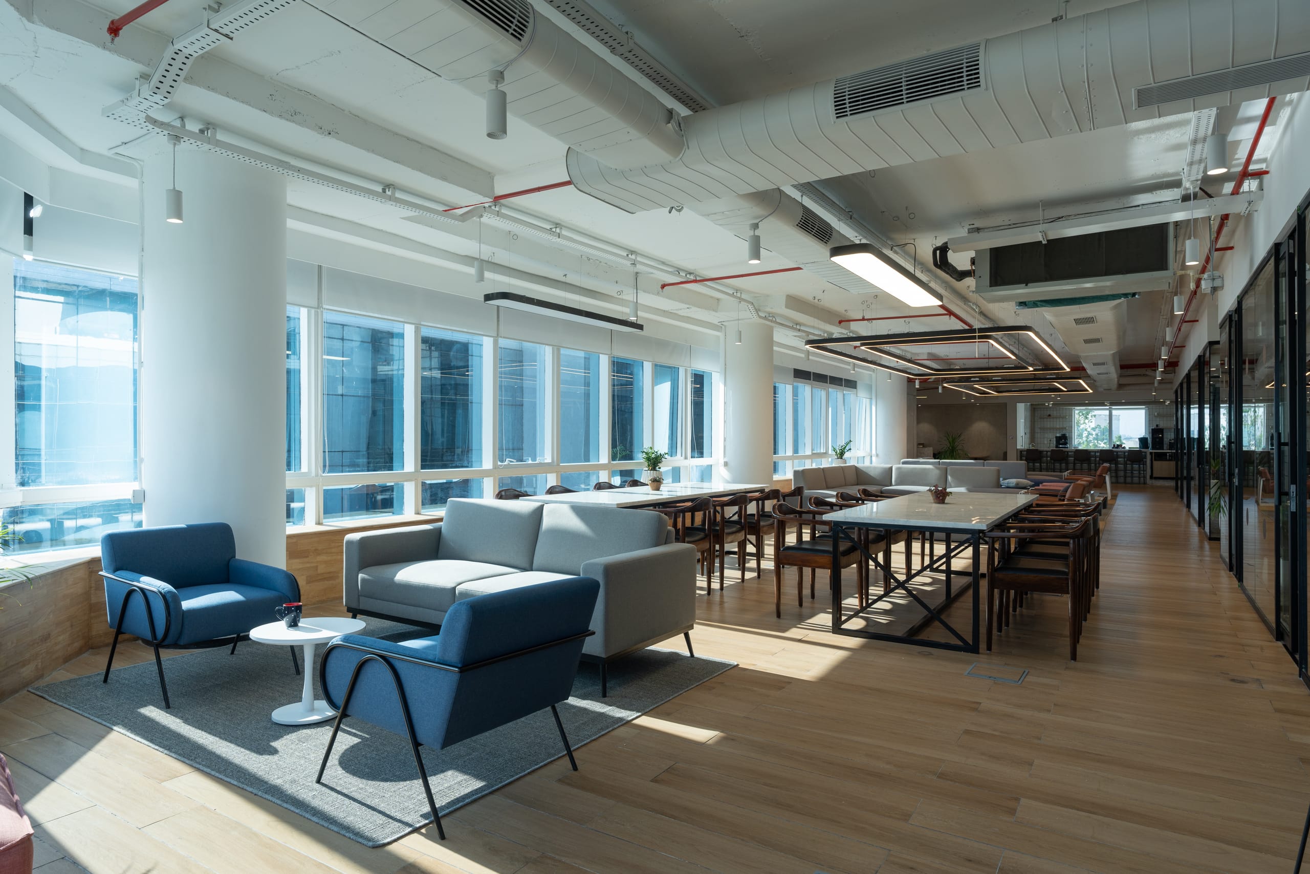 Window-side breakout lounge with full-height glazing at MOSS office