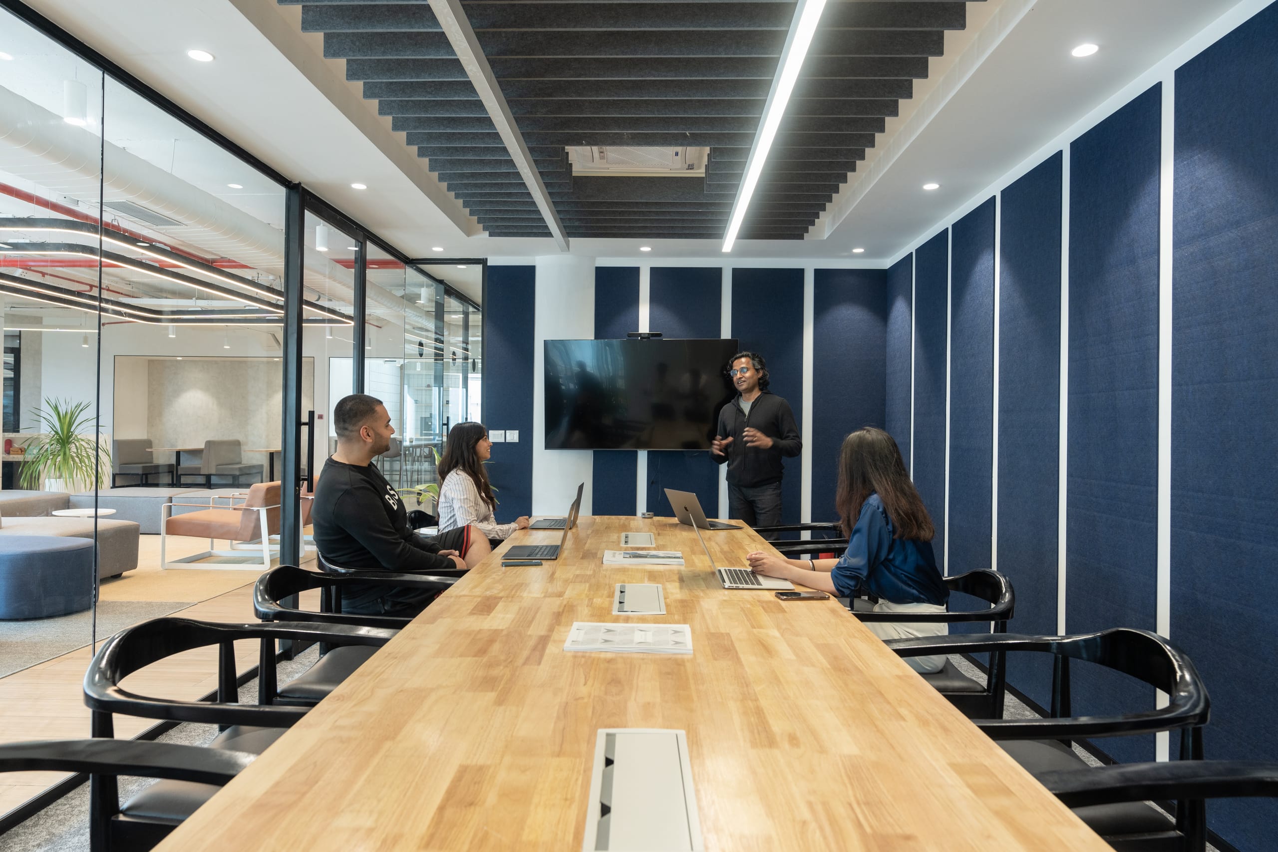 Deep-blue meeting room in use at MOSS office