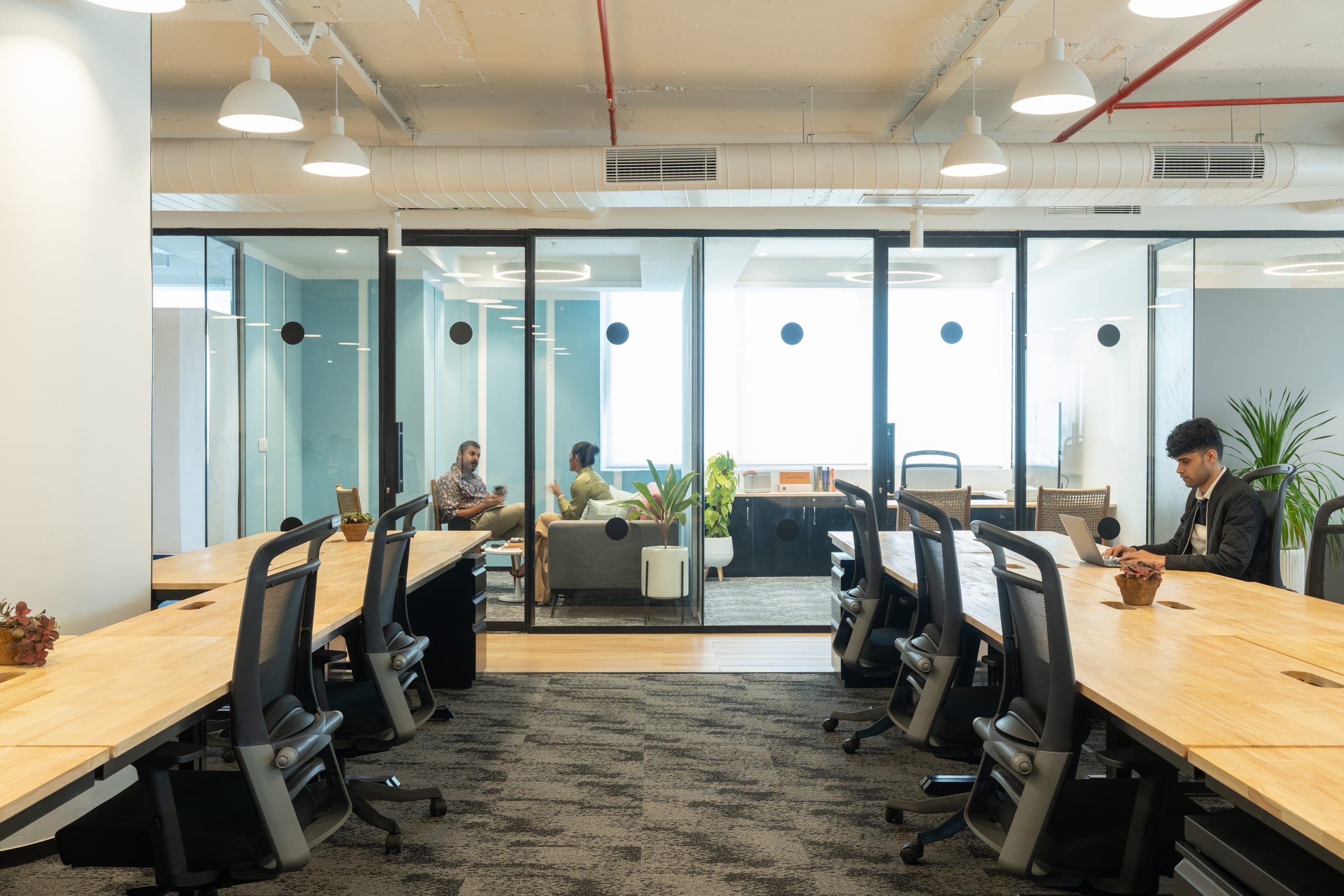 Timber-floored passage between workstations at MOSS office