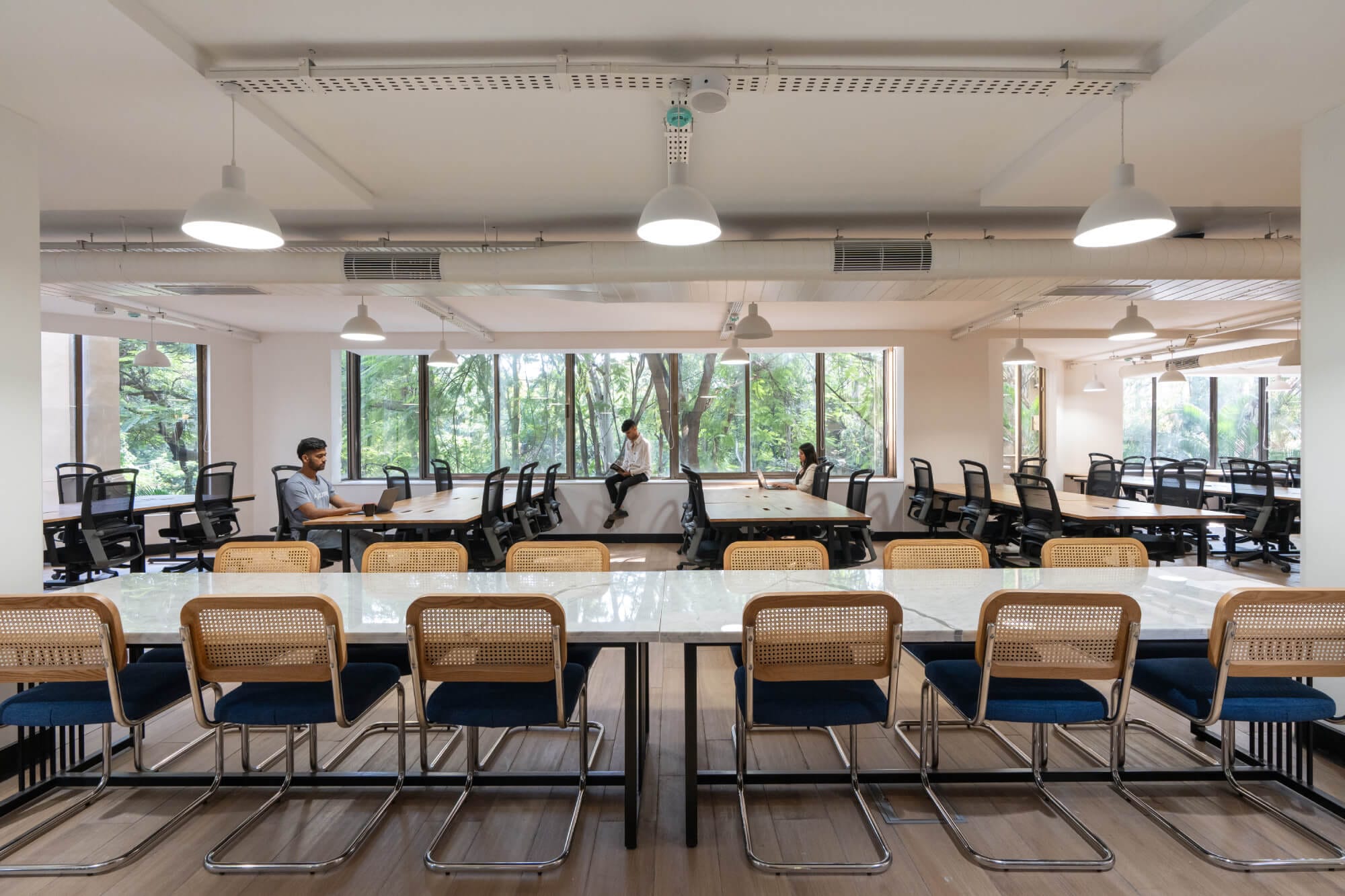 Open-plan workstations along the glazing at the MOSS Golden Enclave office