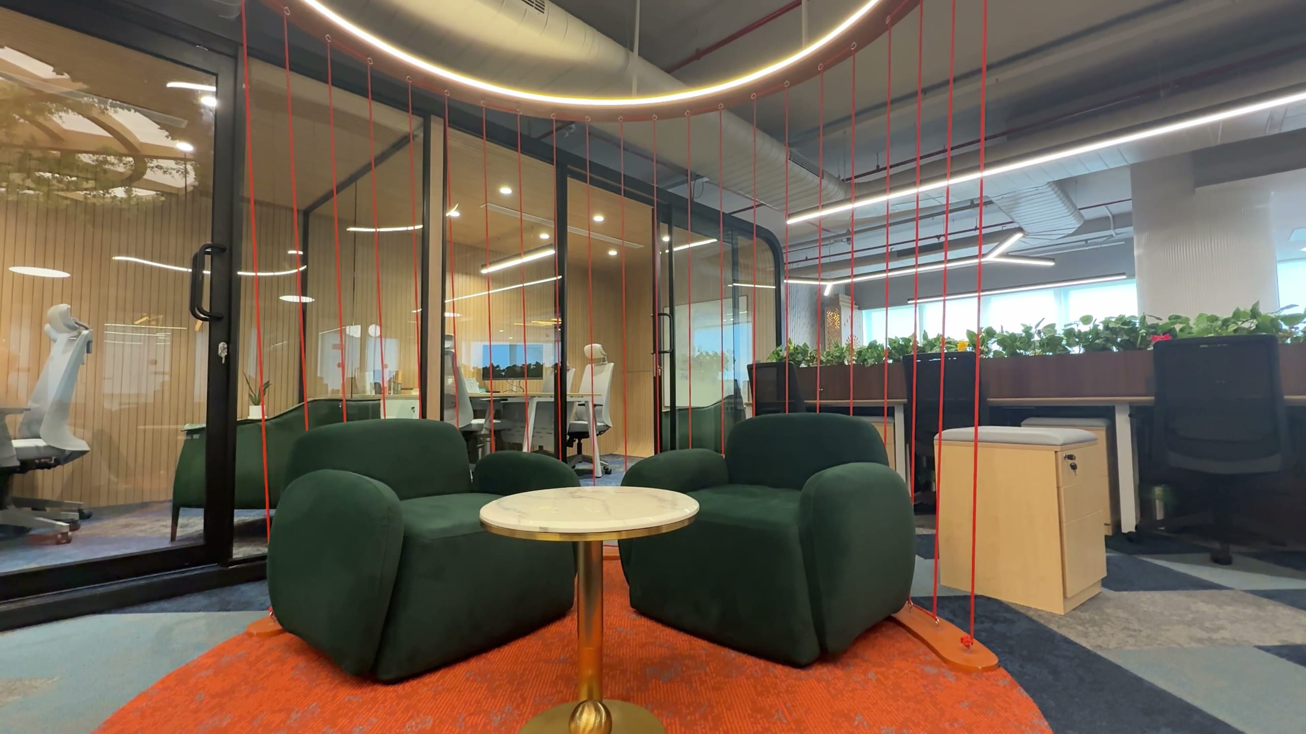 Green sofa seating in the Rugr office breakout area
