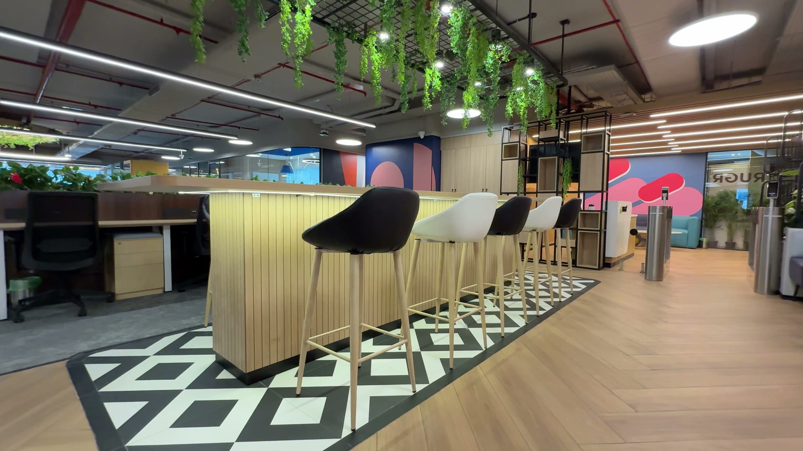 Standing coffee bar and breakout seating in the Rugr office workspace