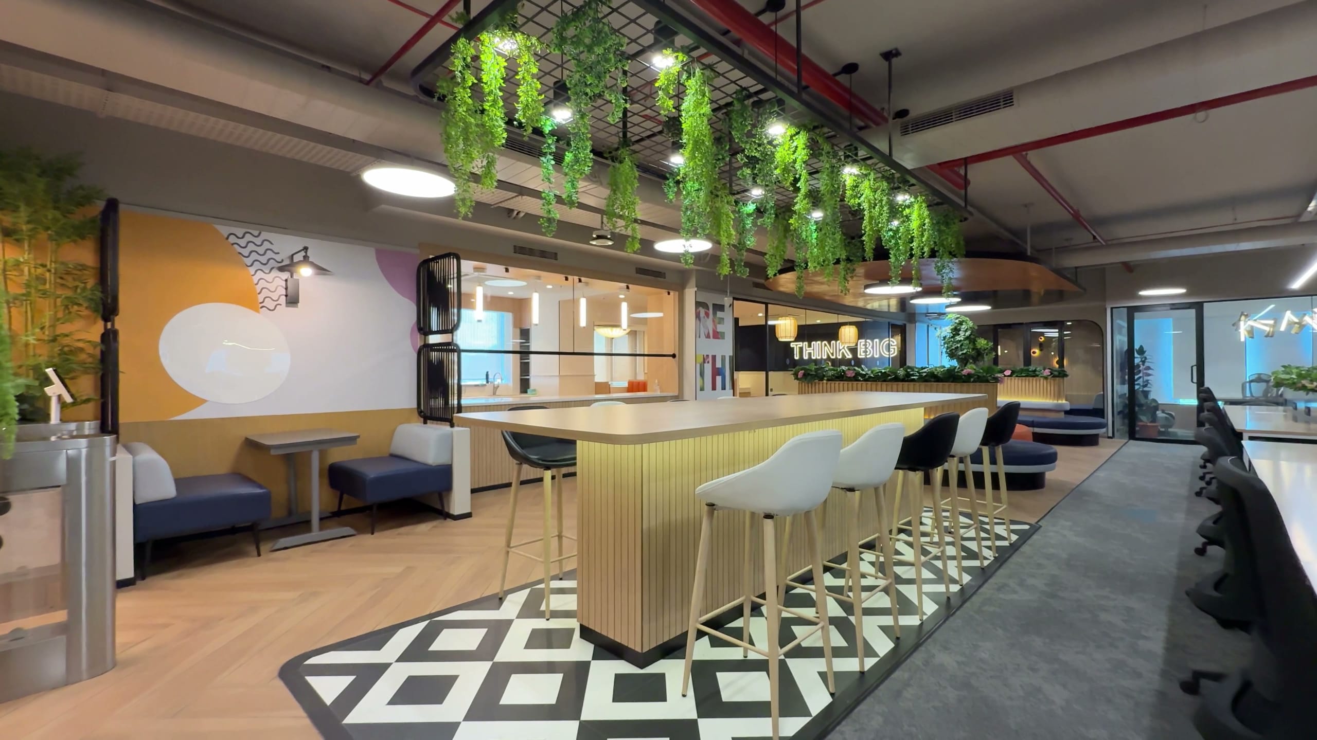 Breakout area with workstations and hanging greenery, Rugr office