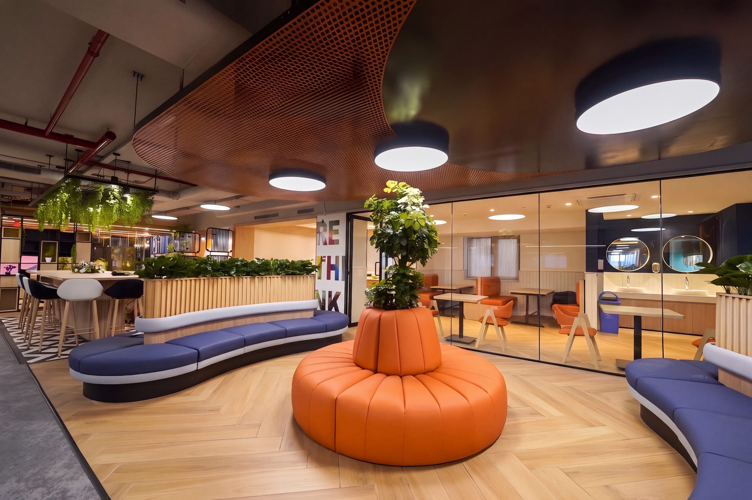 Round orange sofa and informal breakout seating, Rugr office