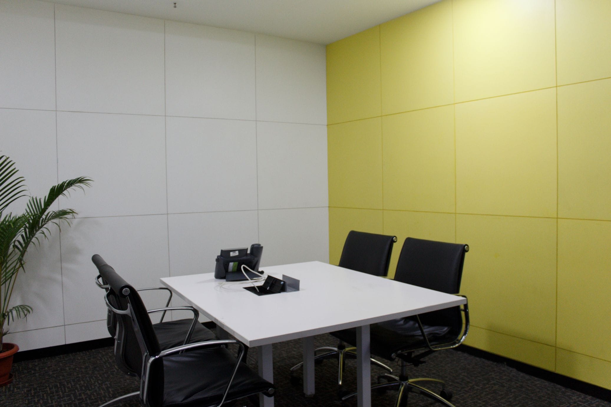 Meeting room with yellow feature wall at Temenos office