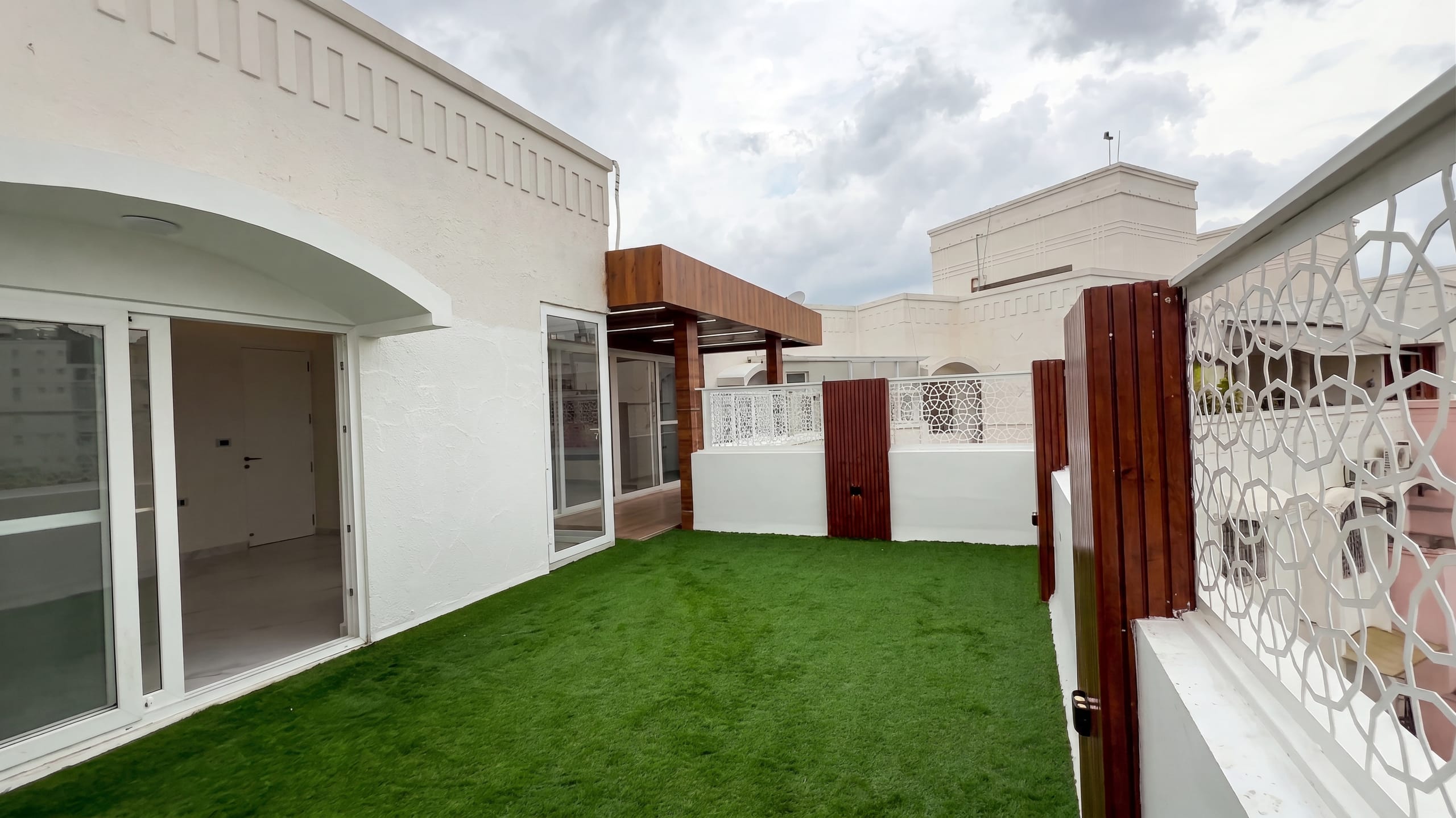 Balcony with green turf at the Diamond District penthouse