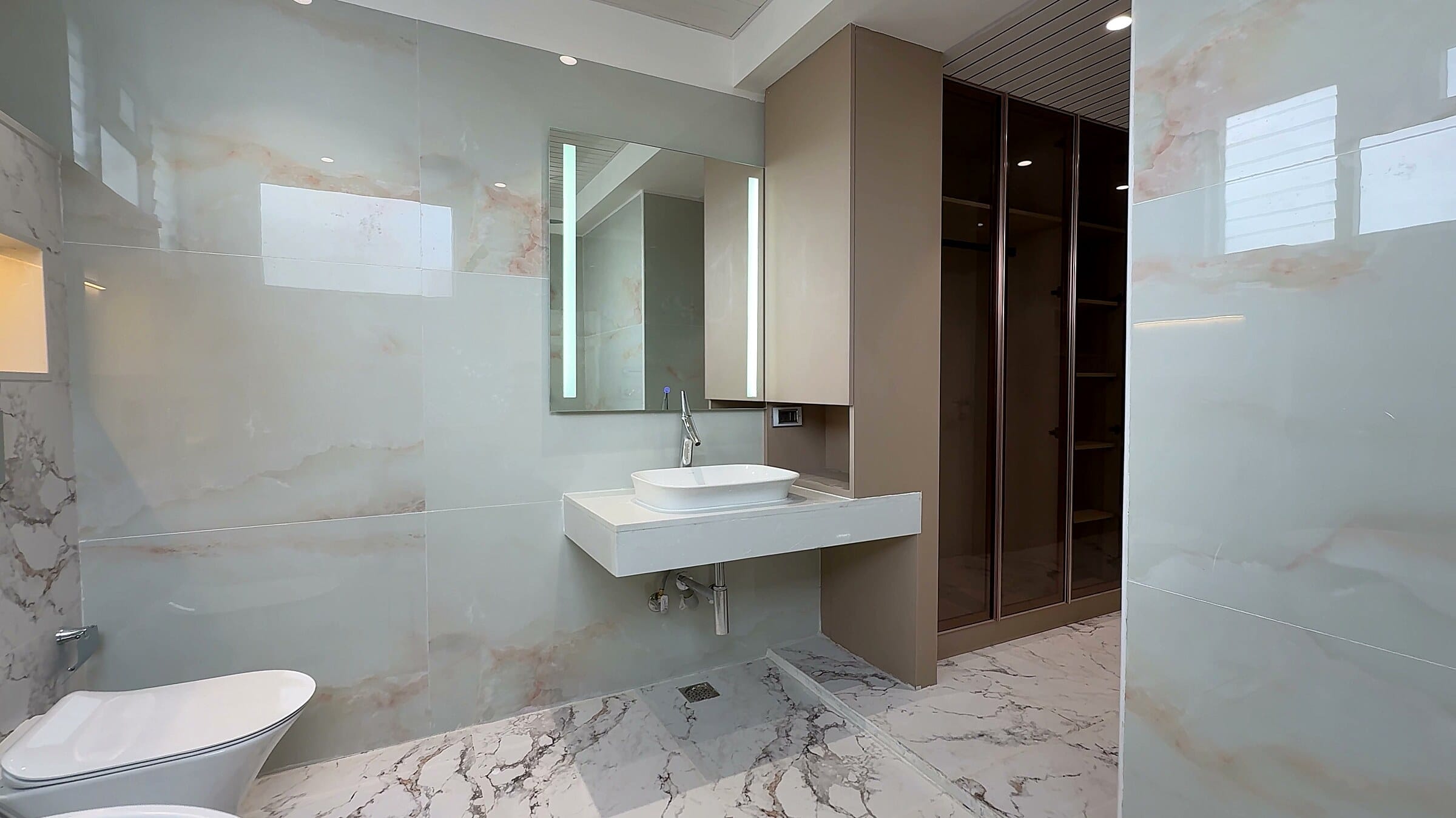 Master bathroom vanity beside the walk-in closet at the Diamond District penthouse