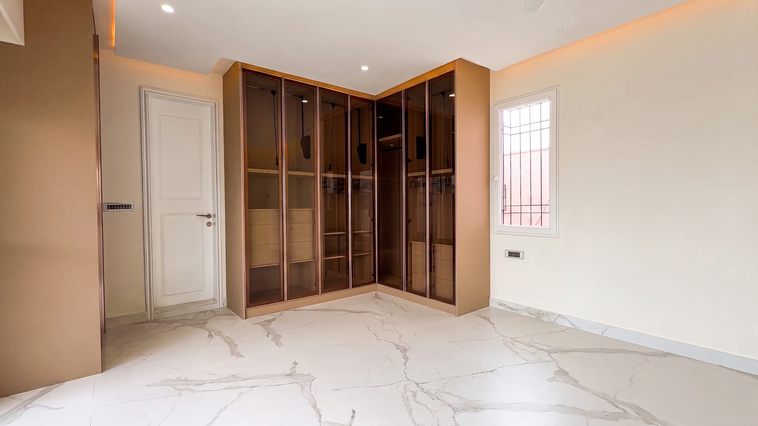 Master bedroom wardrobe in brown finish at the Diamond District penthouse