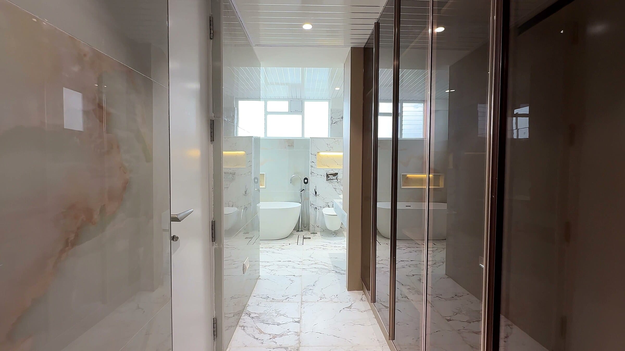 Master suite walk-in closet and bathroom passage at the Diamond District penthouse
