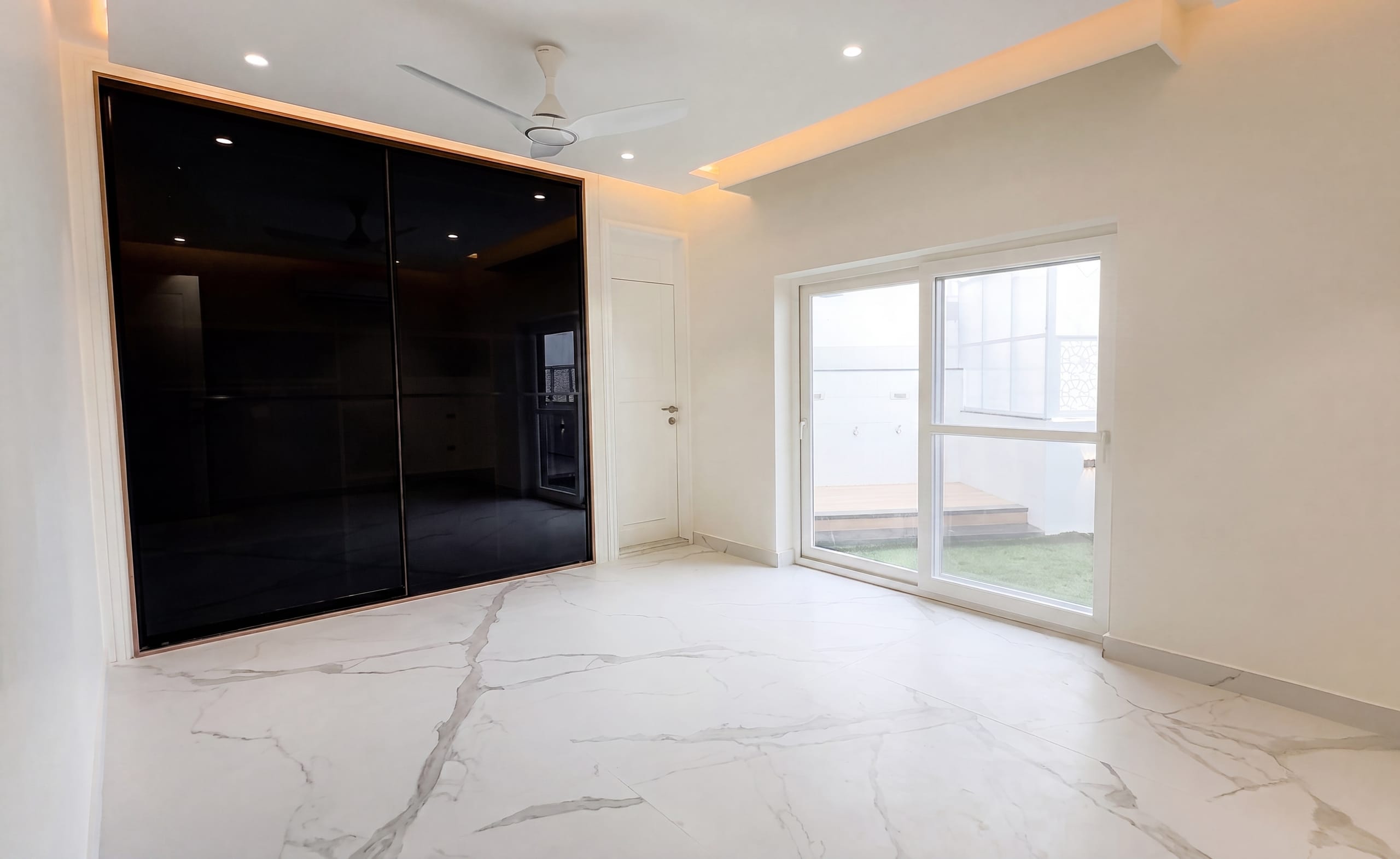 Second bedroom with black glass wardrobe at the Diamond District penthouse