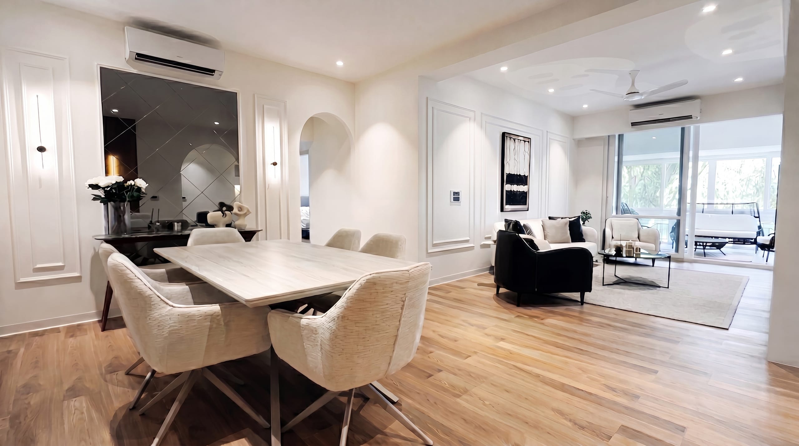 Open-plan dining and living room with timber flooring at the Golden Enclave flat