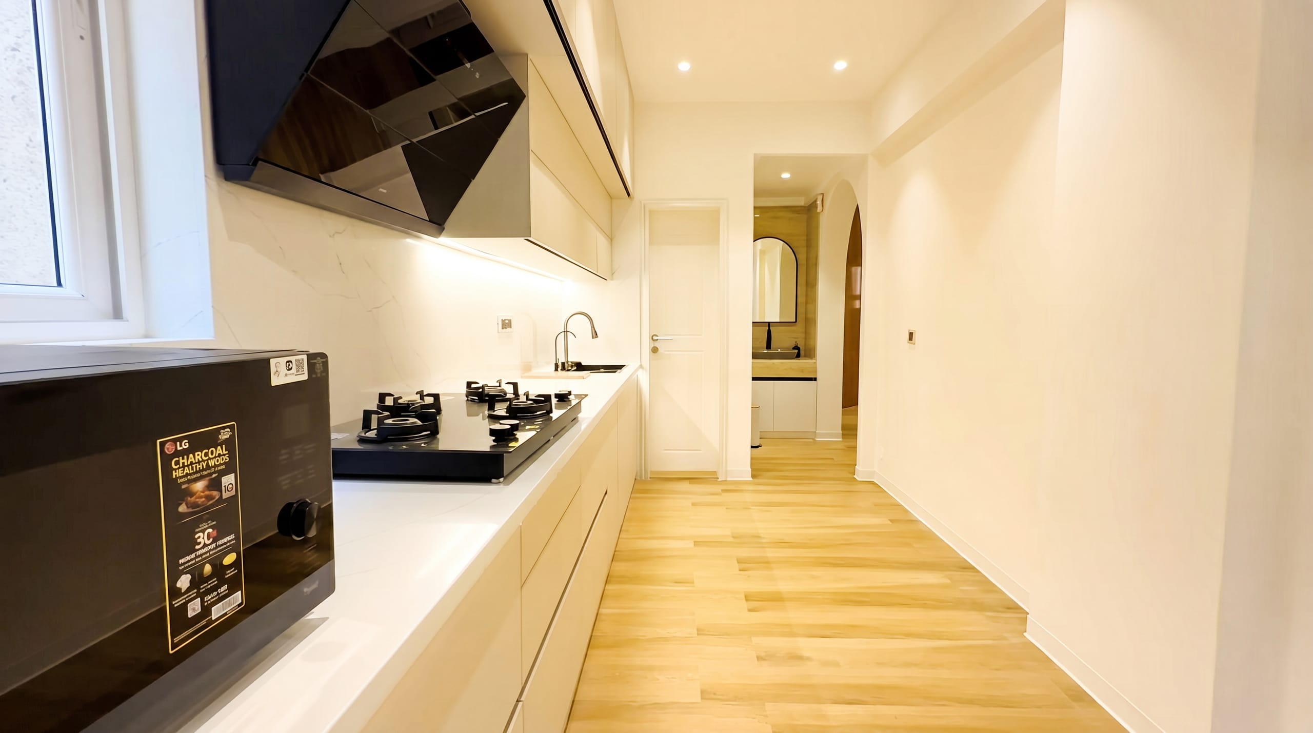 Kitchen with handwash counter and panelled cabinetry at the Golden Enclave flat