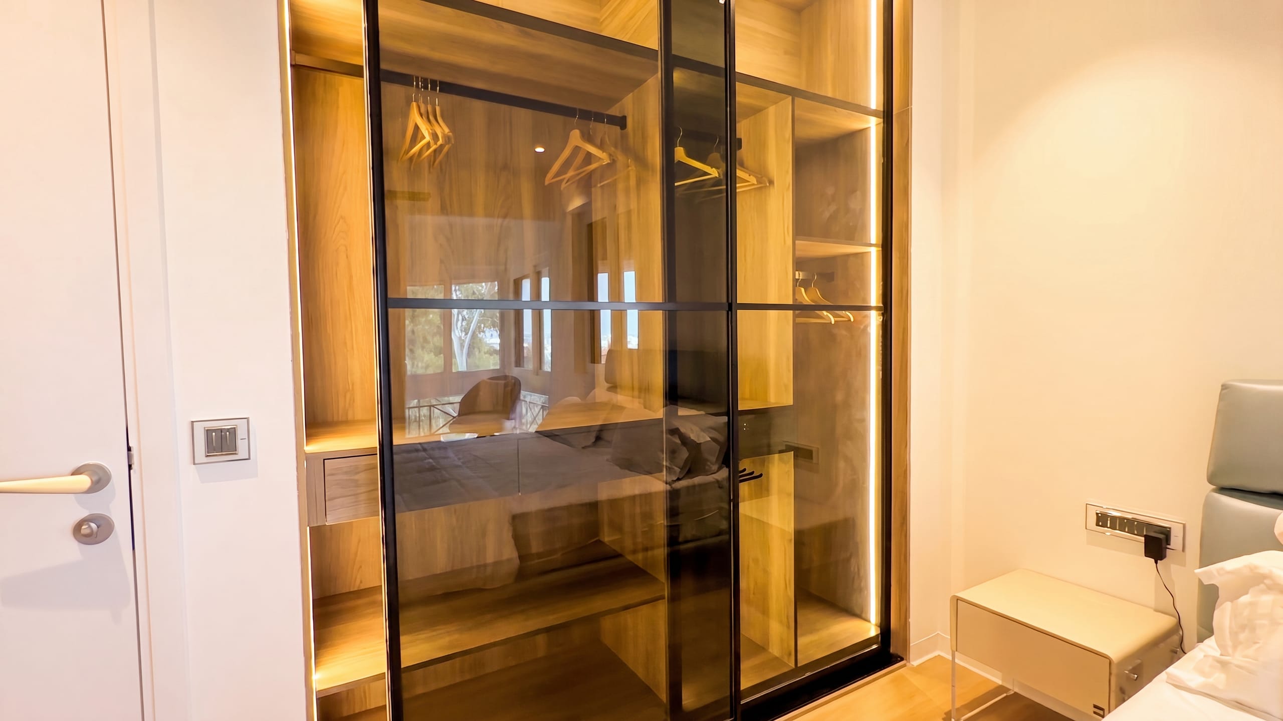 Master bedroom wardrobe interior with integrated lighting, Golden Enclave flat