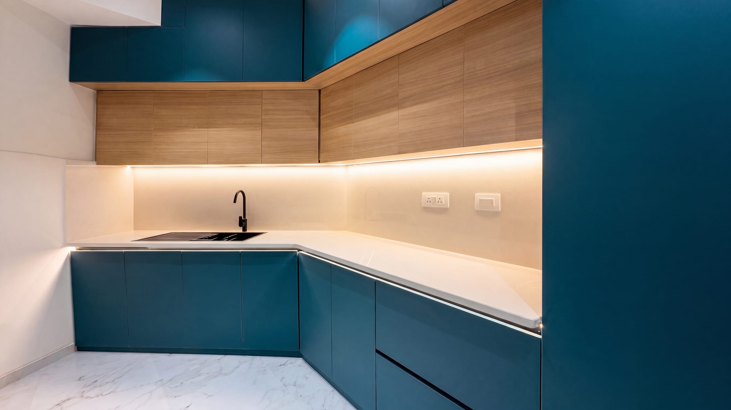 Kitchen sink and cabinetry, left view, at the L13 apartment