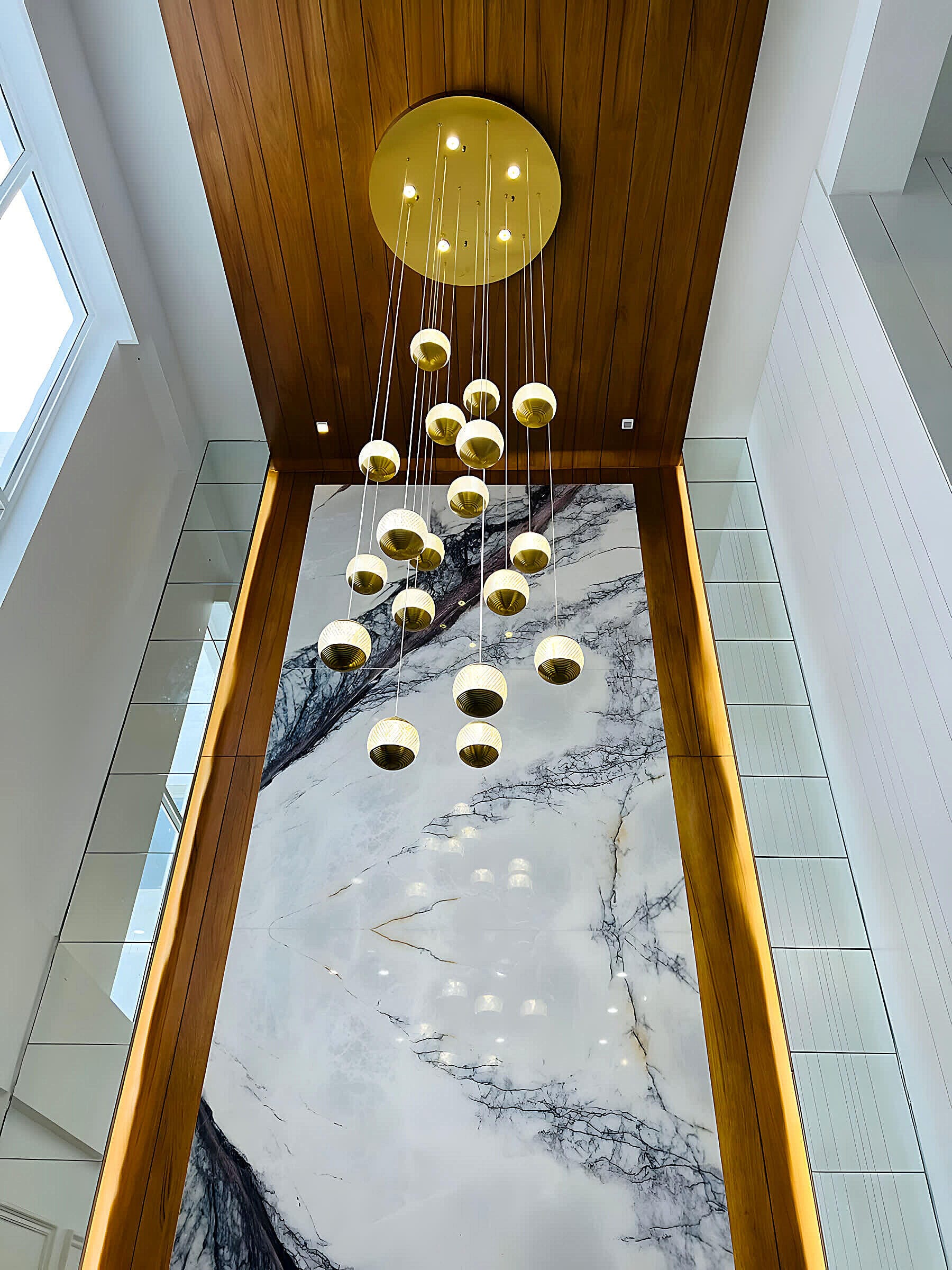 False ceiling with hanging gold spheres at the SMR residence